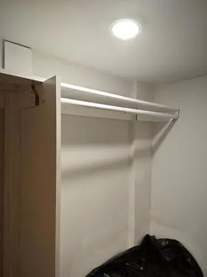 a white shelf in a room with a light at Chamber Inn in Edmonton