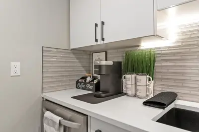 a kitchen with a coffee maker on a counter at Luxury Living Entire Suite-Private in Calgary