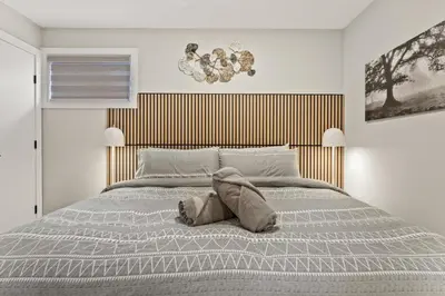 a bedroom with a bed with a stuffed animal on it at Luxury Living Entire Suite-Private in Calgary
