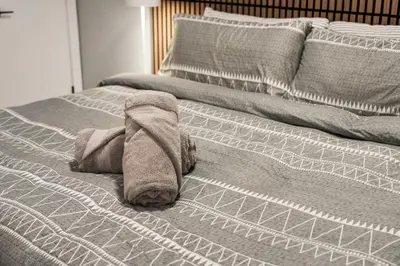 a towel is laying on top of a bed at Luxury Living Entire Suite-Private in Calgary