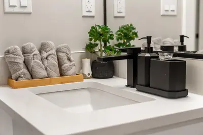 a kitchen counter with a pile of towels on a table at Luxury Living Entire Suite-Private in Calgary