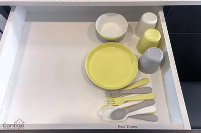 a toy kitchen with some utensils in a drawer at The Nest, 3BR, AC, Near YEG Airport, King Bed! in Edmonton