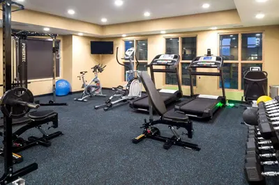 a gym with several treadmills and exercise bikes at Microtel Inn & Suites by Wyndham Red Deer in Red Deer