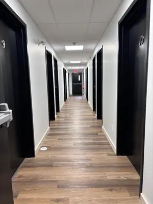 a hallway of an office building with a long corridor at Jasper East Hostel - Near Jasper National Park East Gate Entrance in Jasper