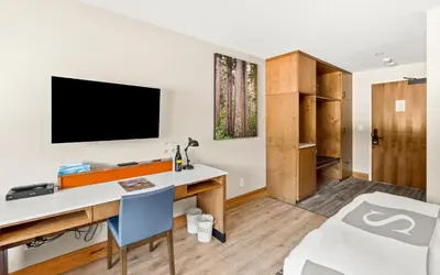 a room with a desk and a tv on a wall at Sproat Lake Landing Resort in Port Alberni