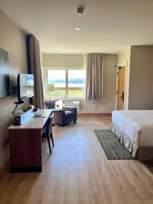 a hotel room with a bed and a desk at Sproat Lake Landing Resort in Port Alberni