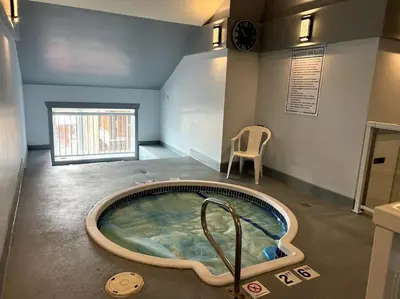 a jacuzzi tub in the middle of a room at Cornerstone Lodge by StayIn in Fernie