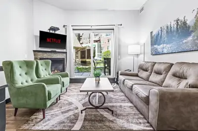 a living room with a couch and two chairs and a fireplace at Mountain Getaway in Canmore - Sleeps 6 - Pool & Hottub in Canmore