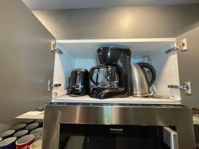 a kitchen with a coffee maker on top of a microwave at Comfortable and Beautiful Brand-New Suite BSMT-Two Bedroom, Two Washrooms in Calgary