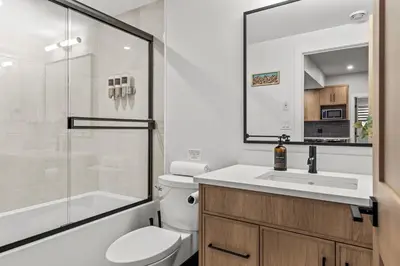 a bathroom with a toilet and a sink and a shower at Sisters Summit Villa by WeekAway Vacations in Canmore
