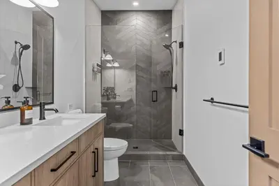 a bathroom with a shower and a toilet and a sink at Sisters Summit Villa by WeekAway Vacations in Canmore