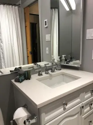a bathroom with a sink and a large mirror at Whistler Gleneagle 27 in Whistler
