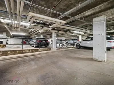 a parking lot with cars parked in a parking garage at Urban Pop Loft, Near ICE District, UG Parking in Edmonton