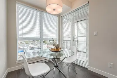 a dining room with a glass table and white chairs at Be The Lively Cityzen In Cityzen in Victoria