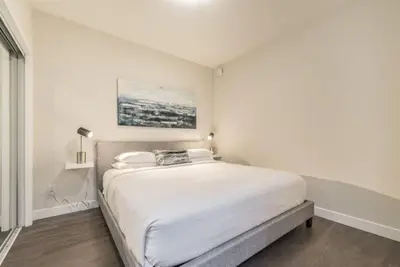 a white bedroom with a large bed in it at Be The Civilised Cityzen In Cityzen in Victoria