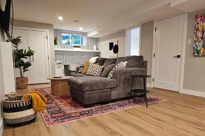a living room with a couch and a table at Boho Bliss - Just steps away from the Hospital in Prince George