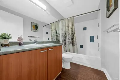 a bathroom with a sink and a toilet and a shower at Lovely 2-Bedrooms Downtown suite Free Parking in Vancouver
