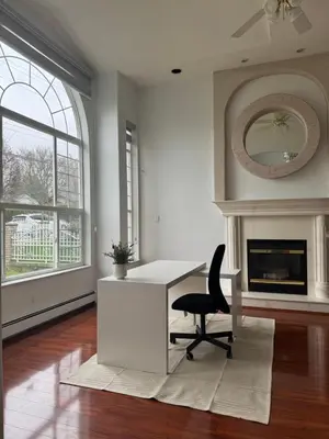 a living room with a desk and a chair at Spacious Getaway in Surrey in Surrey