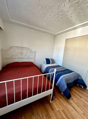 a bedroom with two beds and a ceiling at Charming East Van Home Near DT and Commercial St in Vancouver