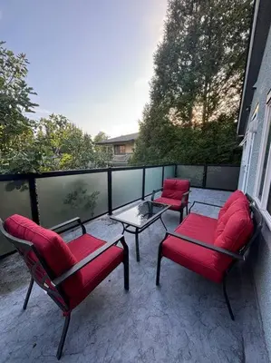 a patio with three chairs and a table on a balcony at Charming East Van Home Near DT and Commercial St in Vancouver