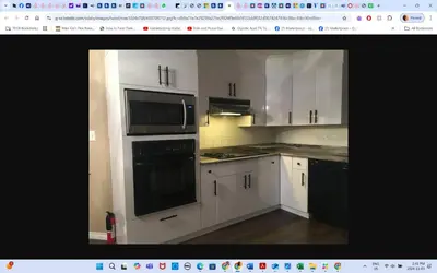 a kitchen with white cabinets and black appliances at Master Bedroom private bathroom 23 minutes airport in Edmonton