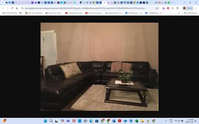 a black leather couch with a coffee table in a living room at Master Bedroom private bathroom 23 minutes airport in Edmonton