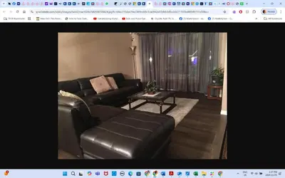 a living room with a leather couch and a table at Main floor room 4, 22 minute from airport in Edmonton