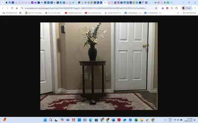 a vase with flowers on a table in a room at Room # 3 Sleep 4 Arrangement in Edmonton