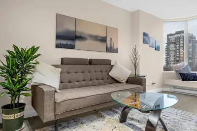 a living room with a couch and a glass table at Beautiful City Two Beds Suite with Free Parking in Vancouver