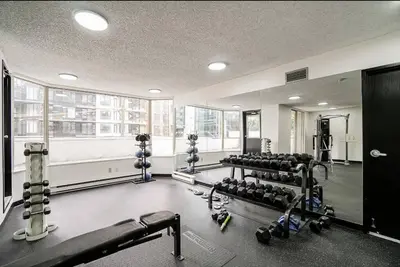 a gym with a lot of equipment in a room at Beautiful City Two Beds Suite with Free Parking in Vancouver