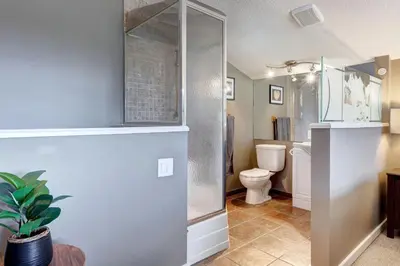 a bathroom with a shower and a toilet at Cozy Condo with Epic Mountain Views, Parking, Air Con in Canmore