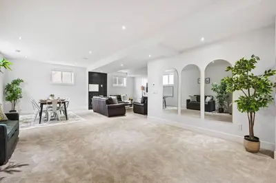 a living room with a couch and a table at Bright & Cozy 2-Bedroom Basement Suite in Chestermere