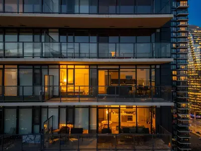 a building with a view of a city at Poolside Bliss - 22 FL w Tower Views! FREE Banff Pass, Gym, Parking, Summer Outdoor Pool! in Calgary