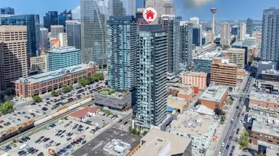 an aerial view of a large city with cars at Poolside Bliss - 22 FL w Tower Views! FREE Banff Pass, Gym, Parking, Summer Outdoor Pool! in Calgary