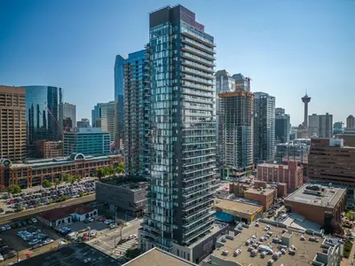 a tall building in the middle of a city at Poolside Bliss - 22 FL w Tower Views! FREE Banff Pass, Gym, Parking, Summer Outdoor Pool! in Calgary