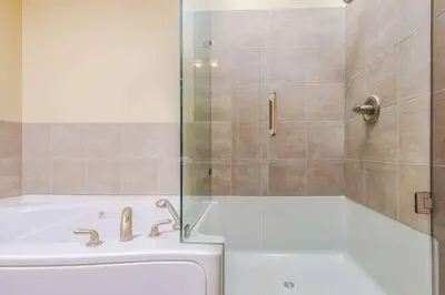 a bathroom with a tub and a shower and a bath tub at Stonegate Resort Unit A206 in Kelowna