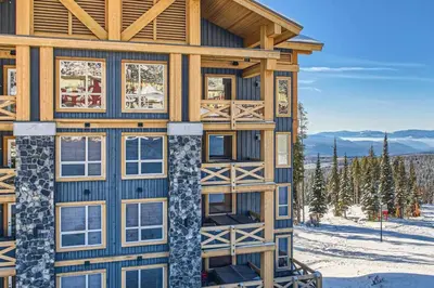 a log cabin in the snow with windows at Stonegate Resort Unit A206 in Kelowna