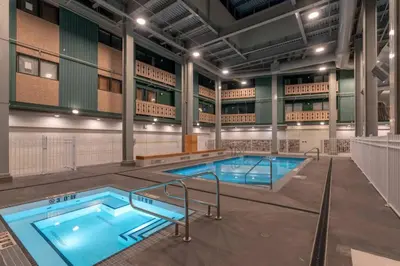 a large swimming pool in a building with two pools at Winter Escape On Perfection - Ski In Out, Pool & Hot Tub in Big White