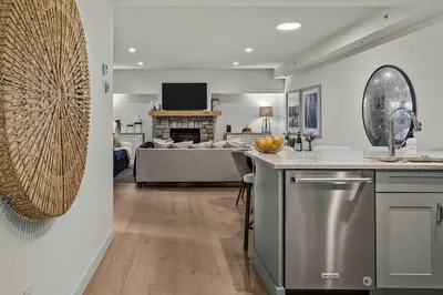 a kitchen and living room with a couch at Spacious 2bed with Hot Tub in Canmore