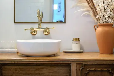 a bathroom sink with a faucet on a wooden counter at The Reef guest suite in Sechelt