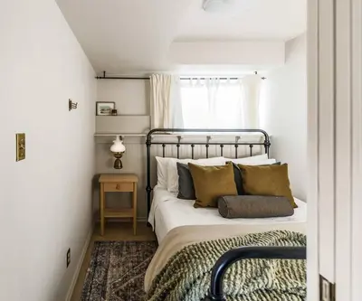 a bedroom with a bed with pillows and a window at The Reef guest suite in Sechelt