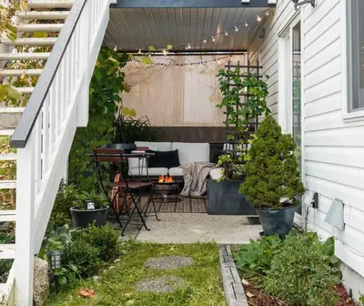 an outdoor patio with a table and a grill at The Reef guest suite in Sechelt