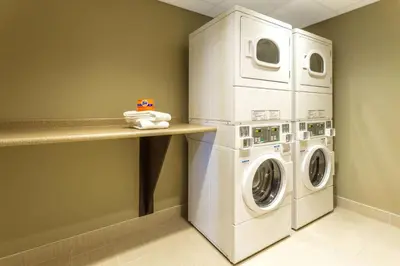 a laundry room with a washer and dryer at Microtel Inn & Suites by Wyndham Whitecourt in Whitecourt