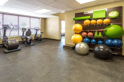 a gym with cardio equipment and exercise bikes at Microtel Inn & Suites by Wyndham Whitecourt in Whitecourt