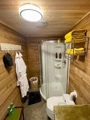 a bathroom with a glass shower and a toilet at Cozy Cabana with Large Private Outdoor Hot Tub in Nanoose Bay