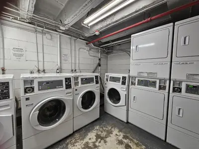 a laundry room with four washing machines and cabinets at Horsethief Lodge by StayIn in Panorama