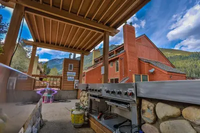 an outdoor kitchen with a stove and a barn at Horsethief Lodge by StayIn in Panorama