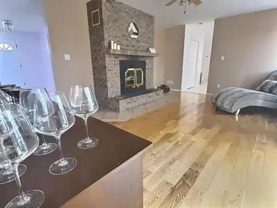 a group of wine glasses sitting on a counter in a living room at Blush Bliss A Peaceful Vineyard Escape in Keremeos