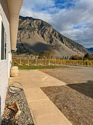 a house with a view of a mountain at Blush Bliss A Peaceful Vineyard Escape in Keremeos