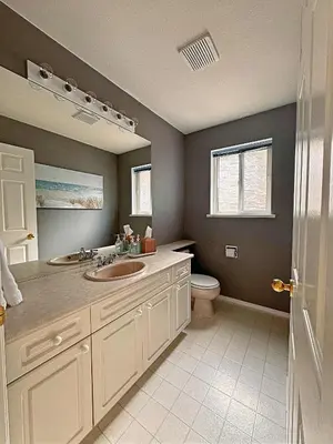 a bathroom with two sinks and a toilet at Blush Bliss A Peaceful Vineyard Escape in Keremeos